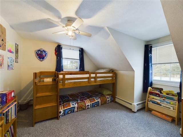 bedroom with a baseboard heating unit, lofted ceiling, multiple windows, and carpet