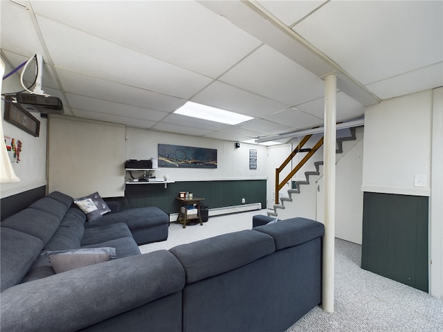 living room featuring carpet floors, baseboard heating, and a drop ceiling