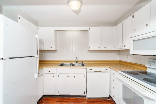 kitchen featuring white appliances, a sink, white cabinetry, light countertops, and backsplash