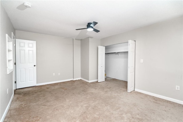 unfurnished bedroom featuring carpet floors, a closet, a ceiling fan, and baseboards