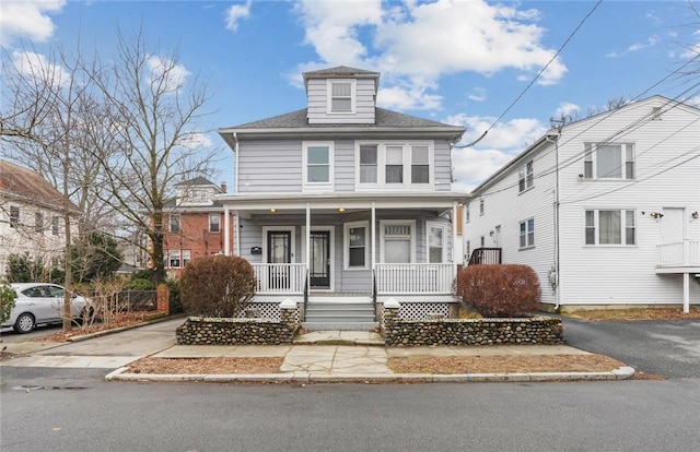 american foursquare style home with covered porch