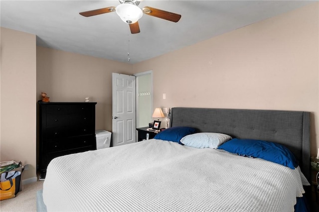 bedroom with light carpet, ceiling fan, and baseboards