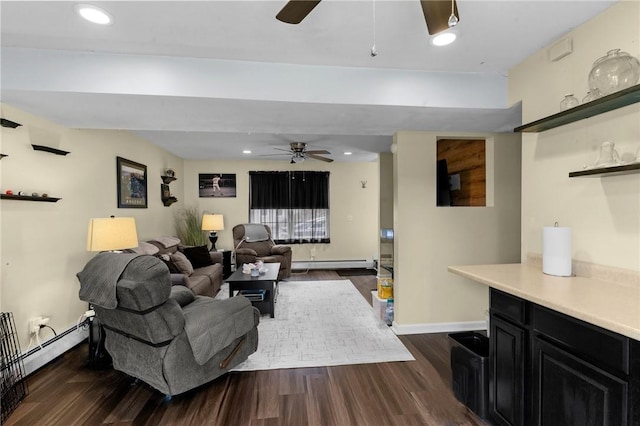 living room featuring ceiling fan, dark wood-style flooring, baseboard heating, and baseboards