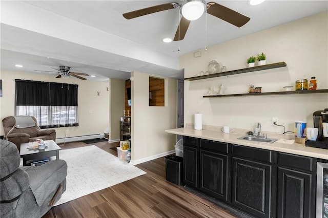 bar with wine cooler, dark wood-type flooring, a baseboard heating unit, a sink, and baseboards