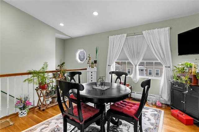 dining room with light wood-type flooring, vaulted ceiling, and recessed lighting