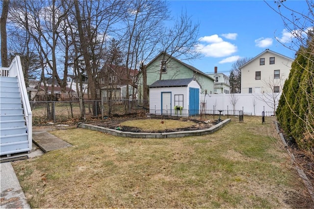 view of yard featuring a storage unit, stairway, an outdoor structure, and a fenced backyard