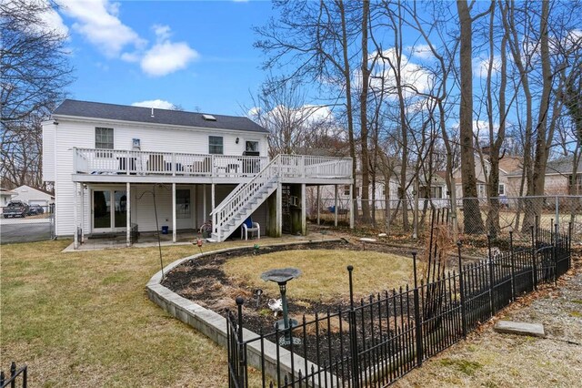 back of house with a fenced backyard, stairway, a lawn, and a wooden deck