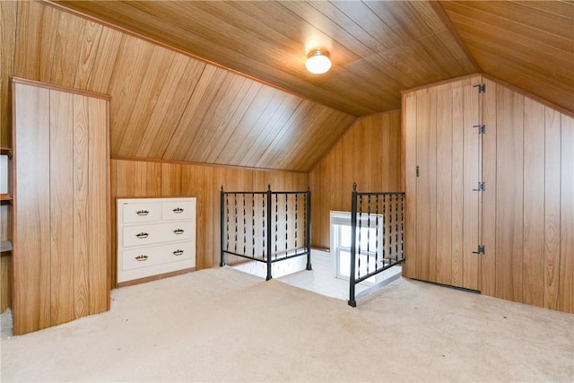 additional living space featuring carpet floors, lofted ceiling, wooden ceiling, and wooden walls