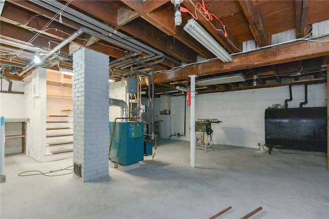 unfinished basement featuring a heating unit and heating fuel