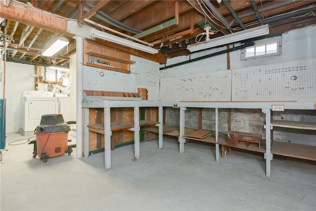 basement with a workshop area and independent washer and dryer