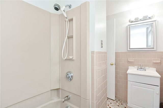 bathroom featuring a wainscoted wall, shower / bathing tub combination, vanity, and tile walls