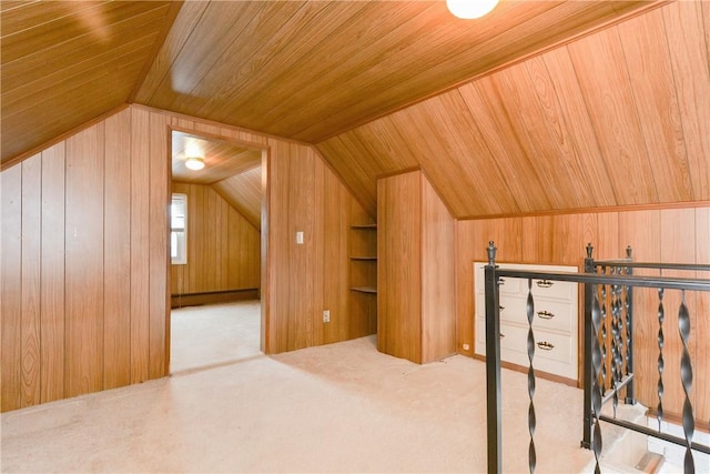 bonus room with built in features, lofted ceiling, wooden ceiling, carpet flooring, and wood walls