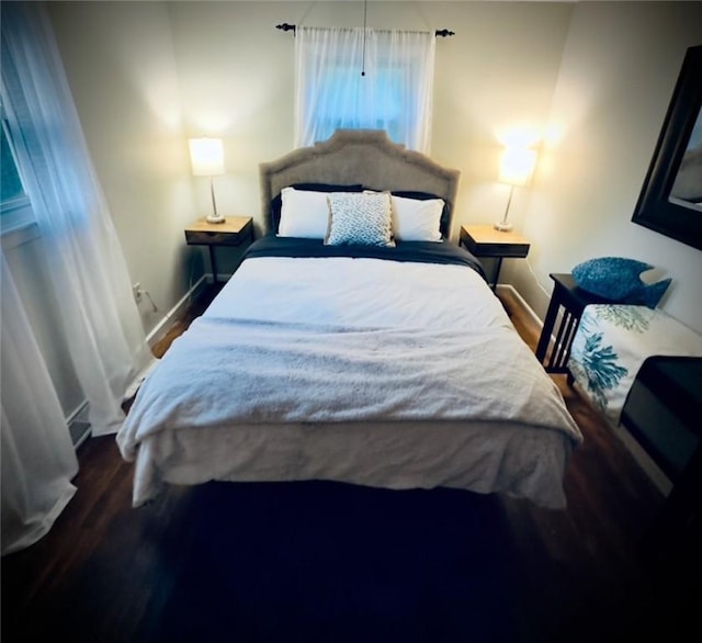 bedroom featuring baseboards and wood finished floors