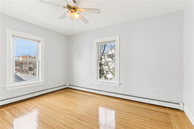 unfurnished room featuring ceiling fan, baseboard heating, and wood finished floors