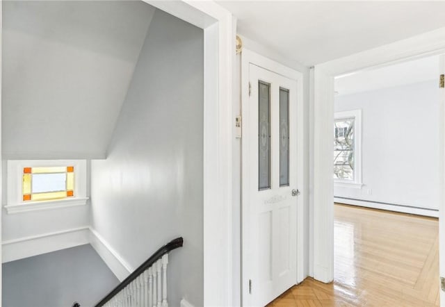 hall featuring an upstairs landing and a baseboard radiator