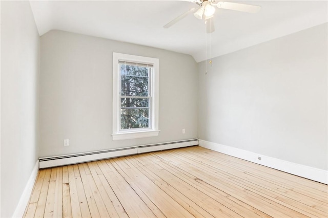 unfurnished room with a baseboard heating unit, lofted ceiling, and wood-type flooring