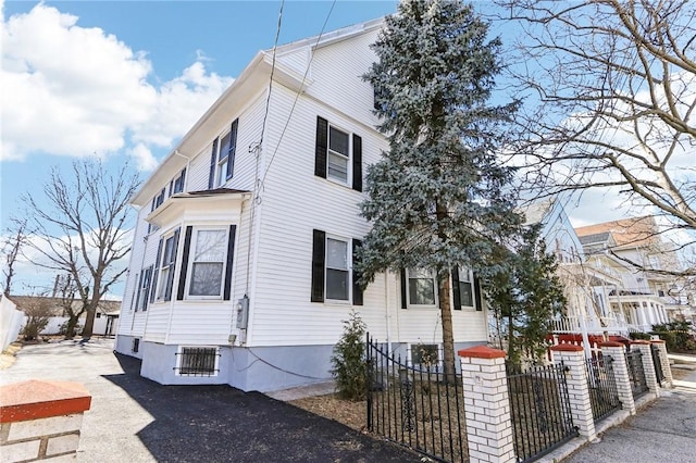 view of side of home featuring a fenced front yard