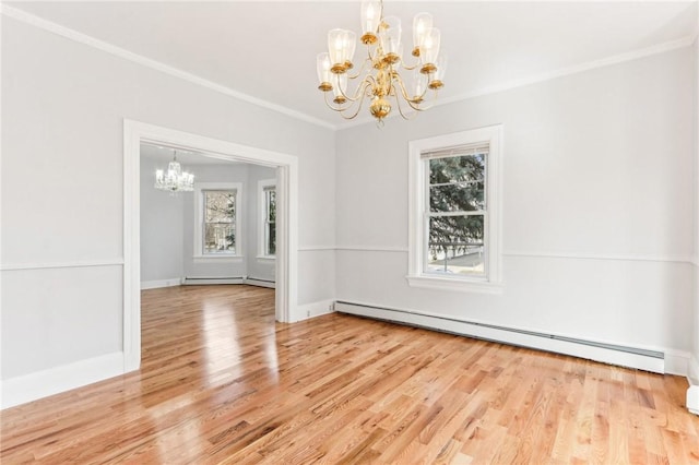 unfurnished dining area featuring ornamental molding, a baseboard heating unit, wood finished floors, an inviting chandelier, and baseboards