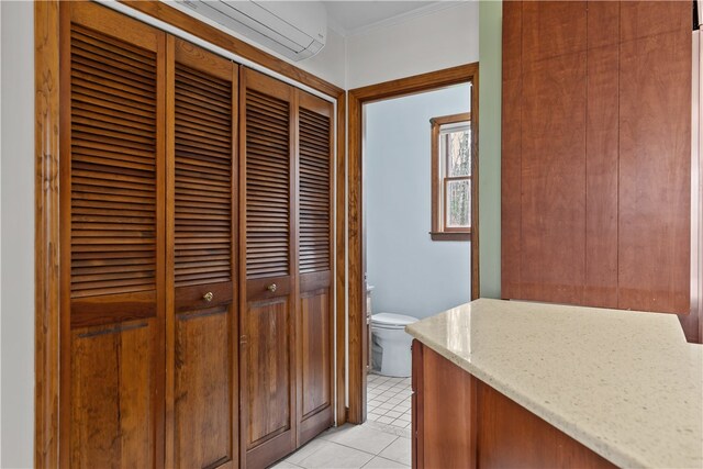 hall featuring crown molding and light tile patterned floors