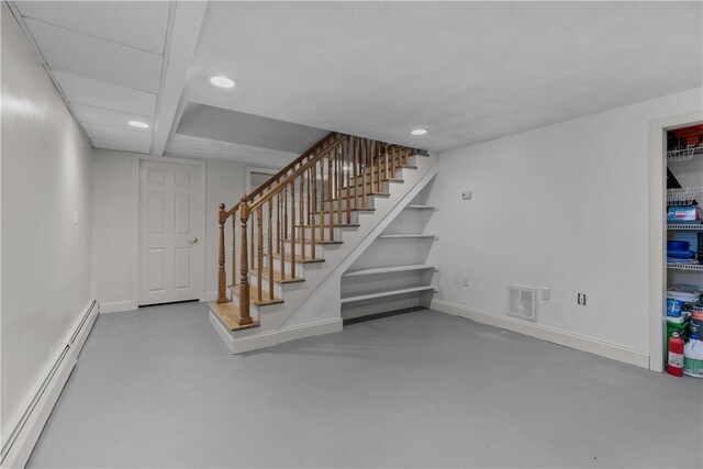 staircase with baseboards, visible vents, baseboard heating, concrete flooring, and recessed lighting