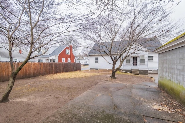 view of yard featuring entry steps and fence