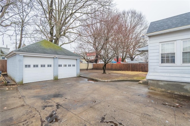 detached garage featuring fence