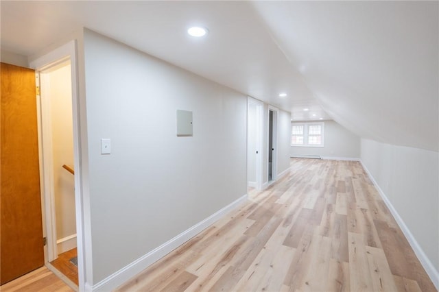 additional living space with vaulted ceiling, recessed lighting, light wood-type flooring, and baseboards