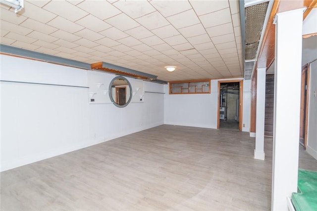 finished basement featuring baseboards and wood finished floors