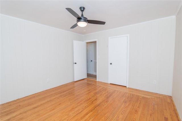 spare room featuring crown molding, ceiling fan, and wood finished floors