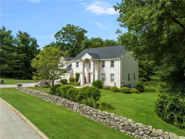 colonial inspired home with a front yard