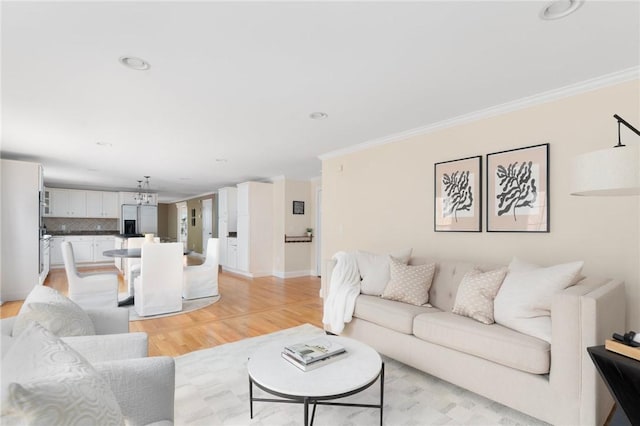 living area with recessed lighting, crown molding, light wood-style flooring, and baseboards