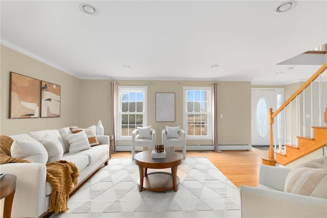 living area with stairway, baseboard heating, crown molding, light wood-style floors, and recessed lighting