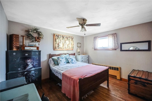 bedroom featuring radiator, ceiling fan, baseboards, and wood finished floors