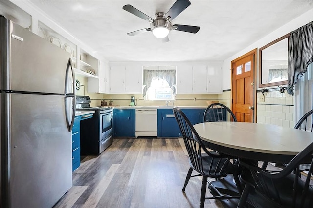 kitchen with electric stove, dark wood-style flooring, blue cabinetry, freestanding refrigerator, and white dishwasher