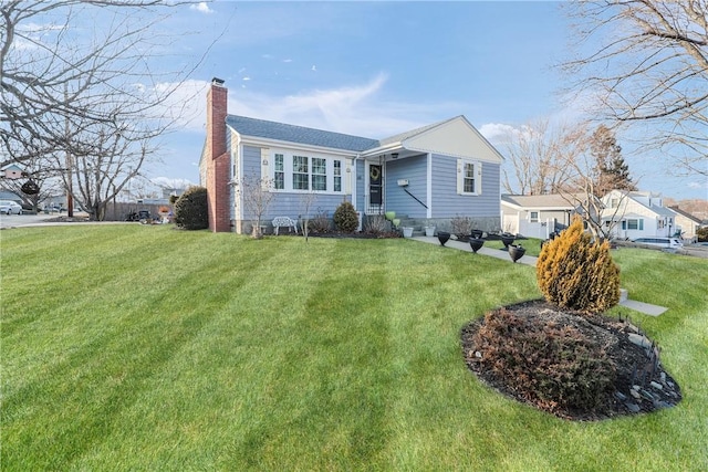 view of front of house with a chimney and a front yard