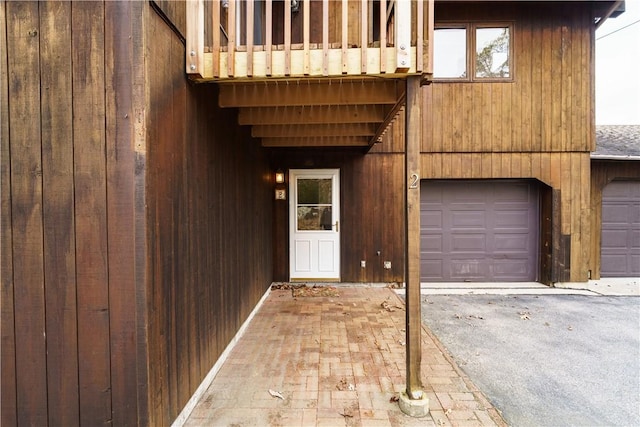 entrance to property featuring an attached garage