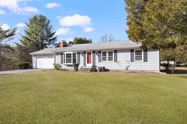 single story home with a front lawn, entry steps, a chimney, a garage, and driveway