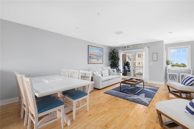 living area with light wood-style floors and baseboards