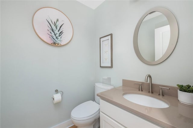 bathroom featuring toilet and vanity