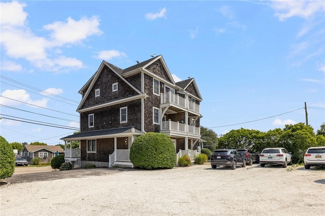 shingle-style home featuring a balcony