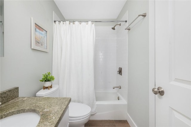 full bathroom with shower / bath combo with shower curtain, vanity, toilet, and baseboards