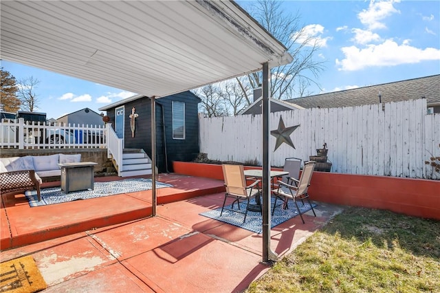 view of patio with outdoor dining space, fence, and an outdoor living space