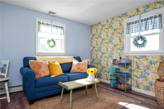 living room with wallpapered walls, baseboards, visible vents, wood finished floors, and baseboard heating