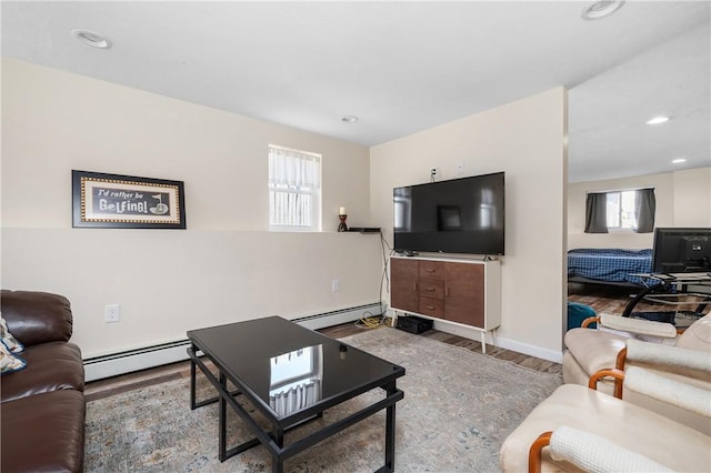 living room with a baseboard heating unit, baseboards, wood finished floors, and recessed lighting