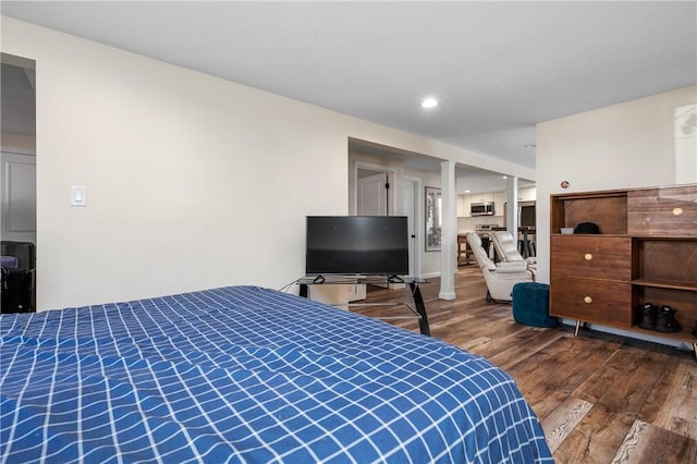 bedroom with wood finished floors and recessed lighting