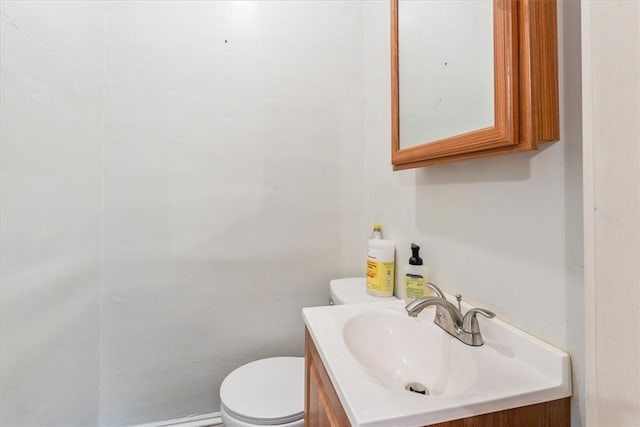 half bathroom with vanity and toilet