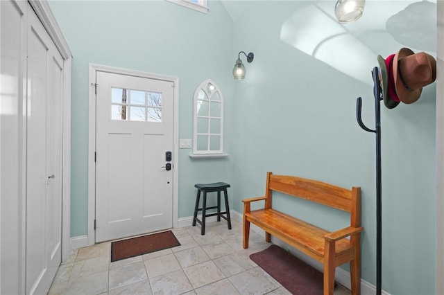 entrance foyer featuring light tile patterned floors and baseboards