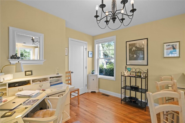 home office with visible vents, baseboards, a notable chandelier, and light wood-style flooring