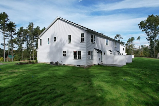 view of property exterior featuring a lawn and central air condition unit