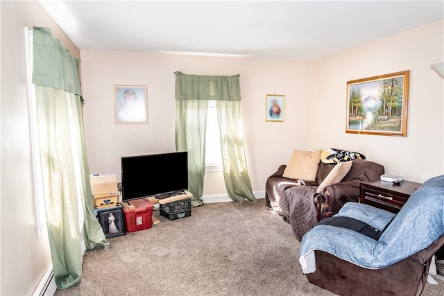 carpeted living area featuring baseboard heating and baseboards